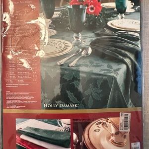 Lenox green w/ holly tablecloth. Pkg is 10” by 14”. Tablecloth is 60” by 120”.